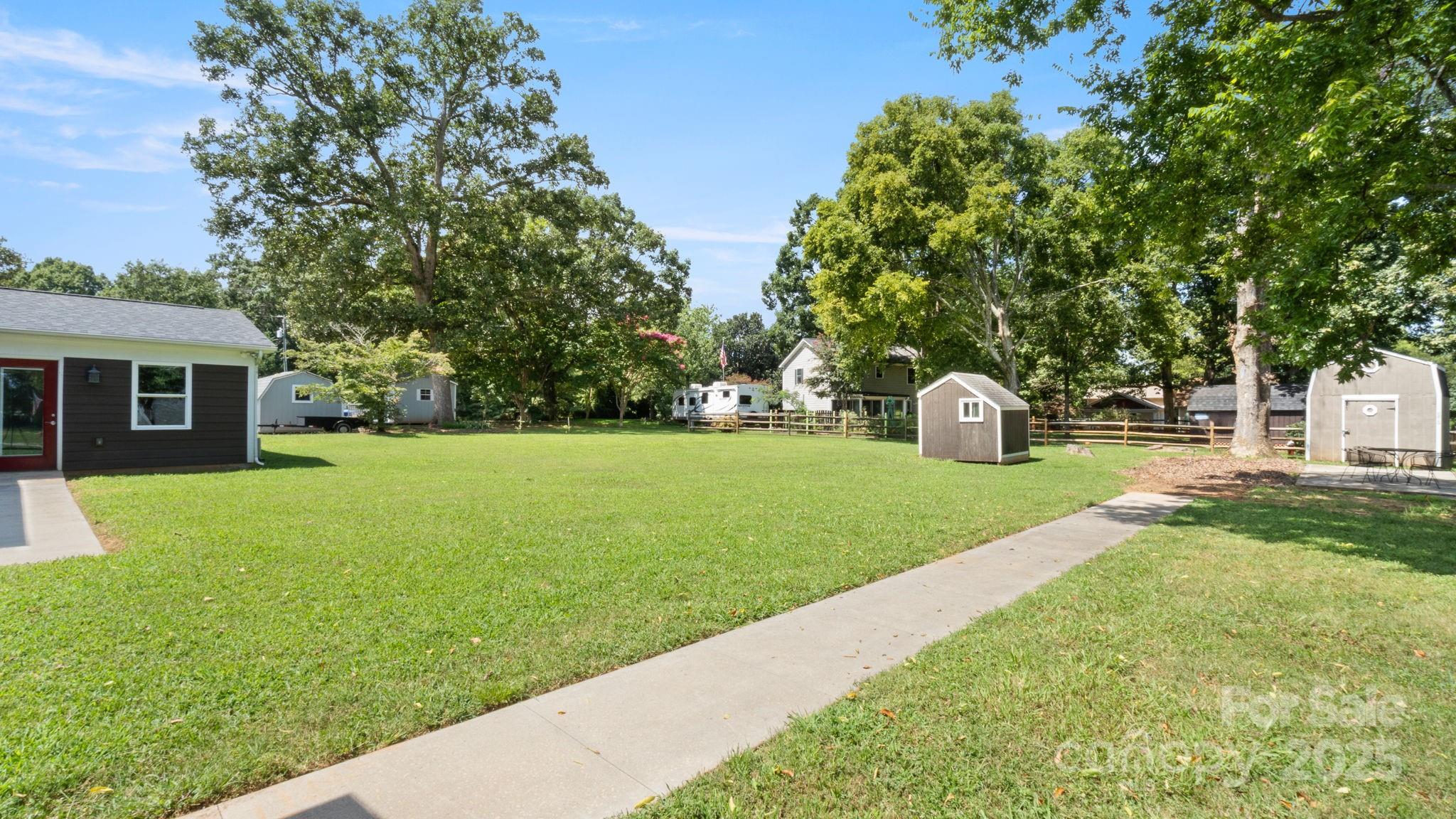 8809 Fairview Road Mint Hill, NC 28227 - Photo 38 of 43 a view of a house with backyard and a garden