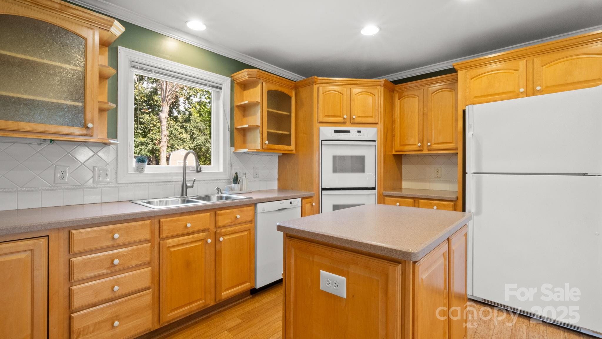 8809 Fairview Road Mint Hill, NC 28227 - Photo 4 of 43 a kitchen with stainless steel appliances granite countertop a sink and a refrigerator