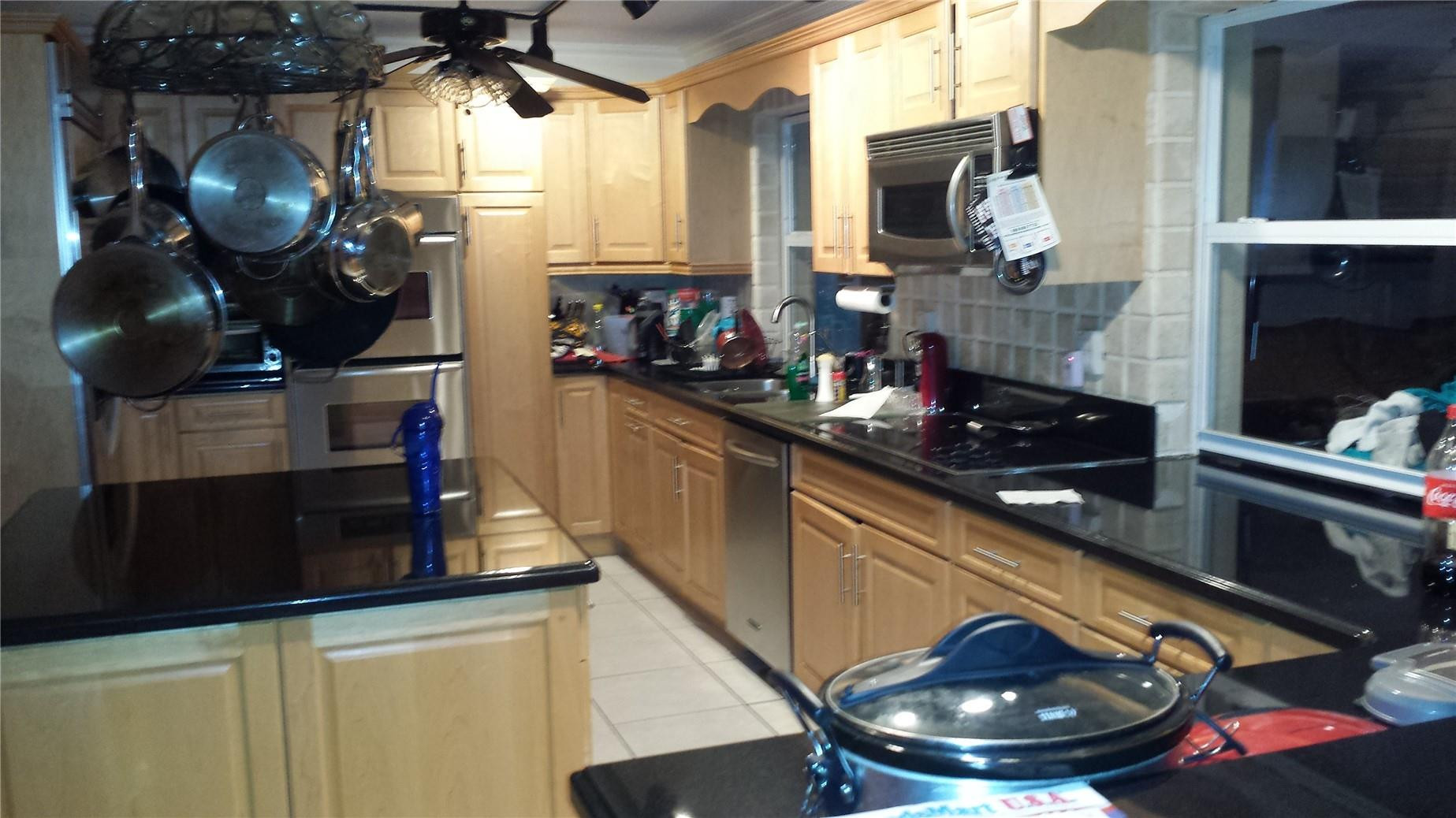 18521 Southwest 55th Street Southwest Ranches, FL 33332 - Photo 16 of 17 a kitchen with a stove and a wooden floor