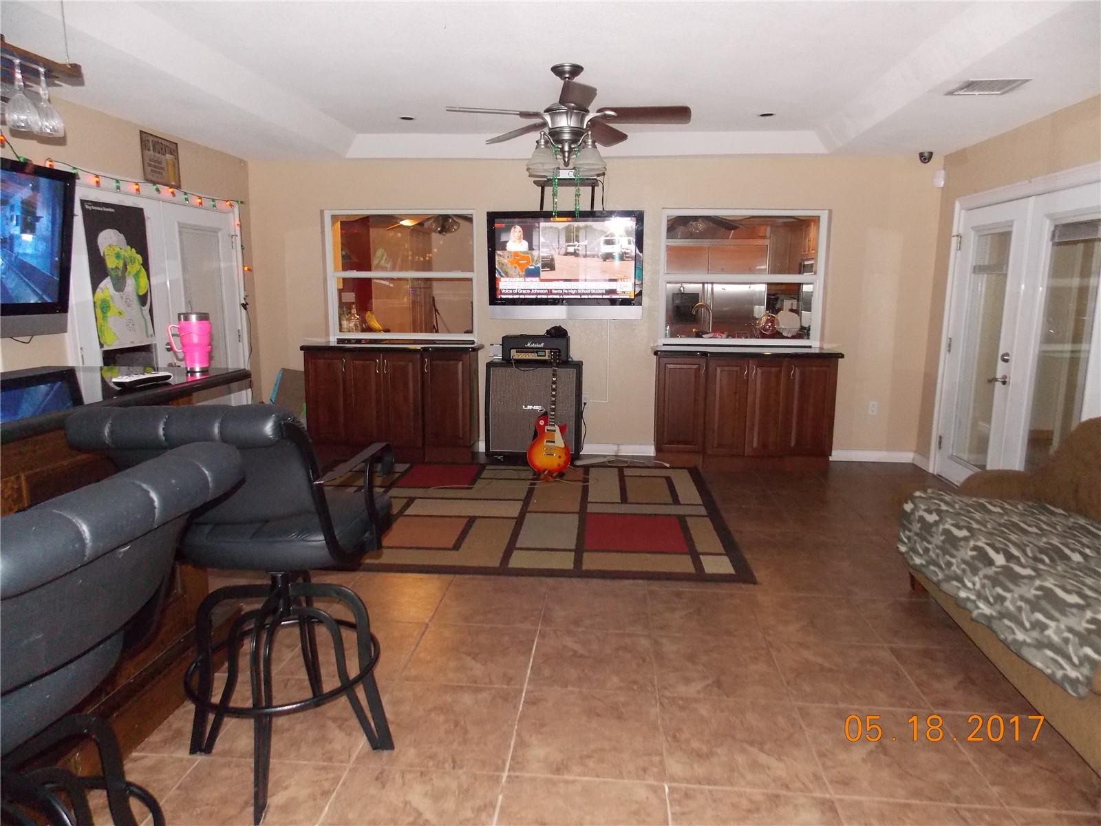 18521 Southwest 55th Street Southwest Ranches, FL 33332 - Photo 17 of 17 a living room with furniture and a flat screen tv