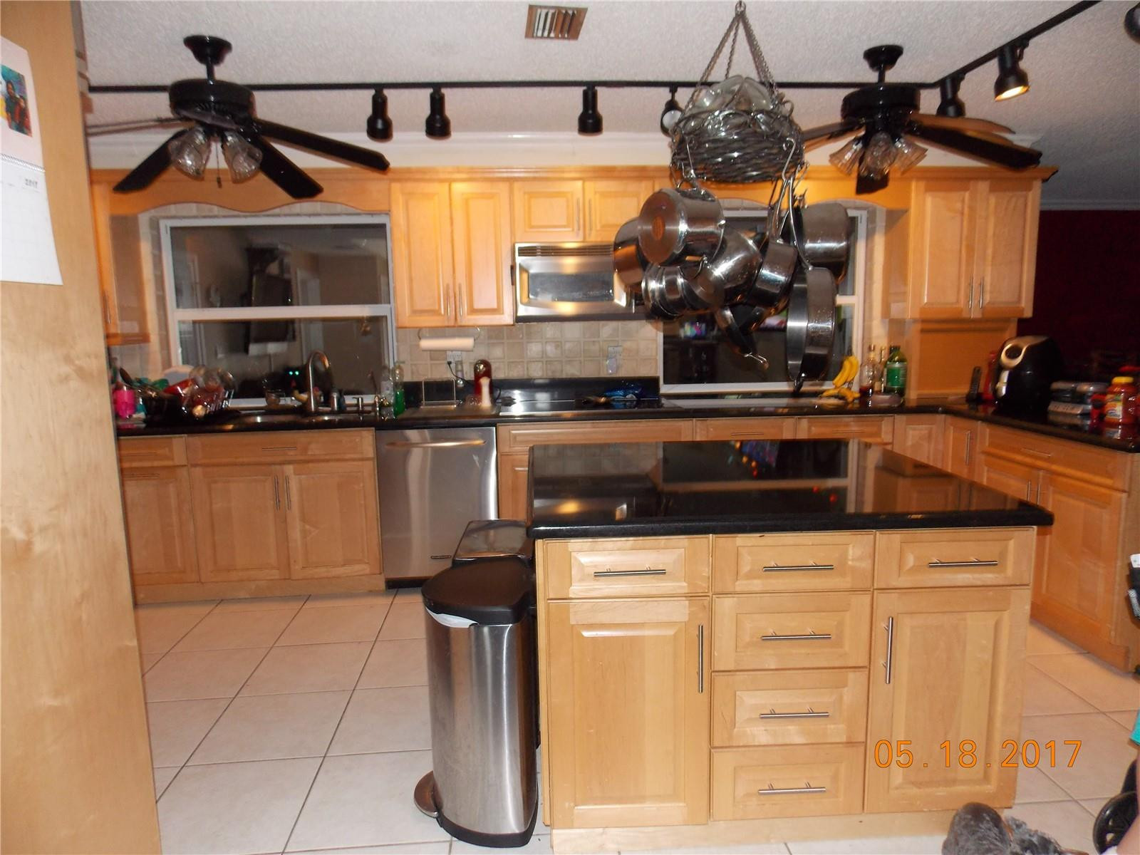 18521 Southwest 55th Street Southwest Ranches, FL 33332 - Photo 3 of 17 a kitchen with stainless steel appliances granite countertop a sink and cabinets