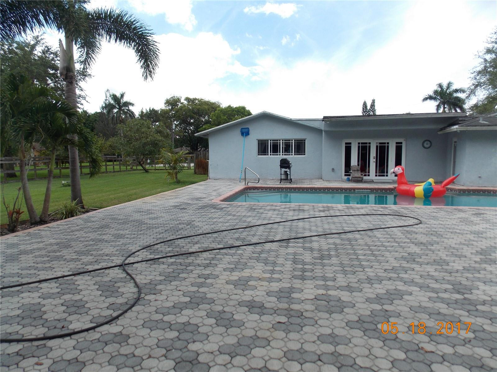 18521 Southwest 55th Street Southwest Ranches, FL 33332 - Photo 10 of 17 a house view with a backyard space