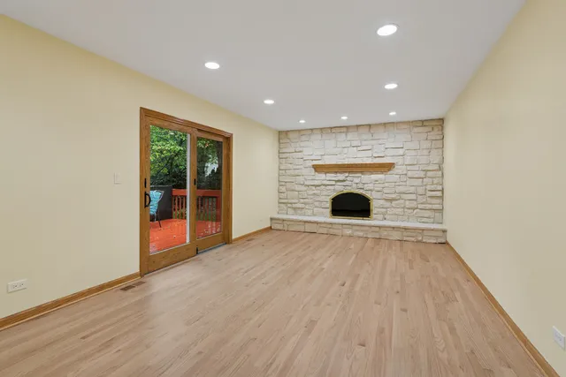 wooden floor in an empty room with a fireplace