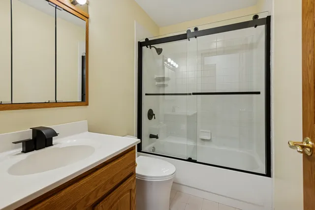 a bathroom with a shower toilet and sink