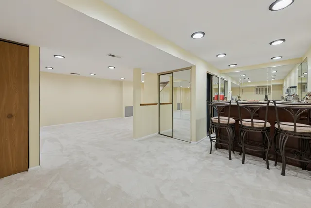 a view of kitchen with refrigerator and chairs