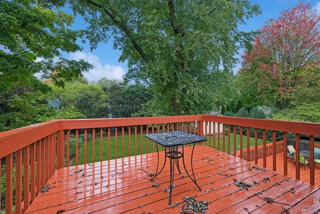a view of a roof deck with wooden floor and fence