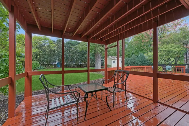 a view of a patio with chairs and wooden floor