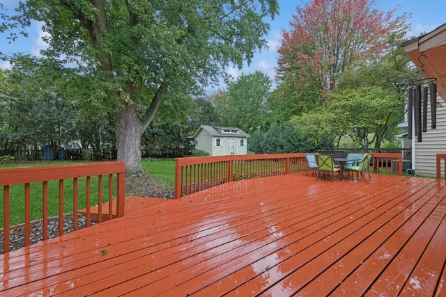 a view of a wooden deck with trees