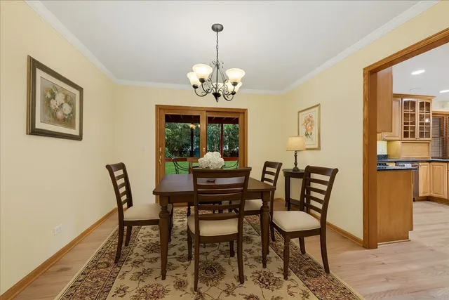 a view of a dining room with furniture and chandelier