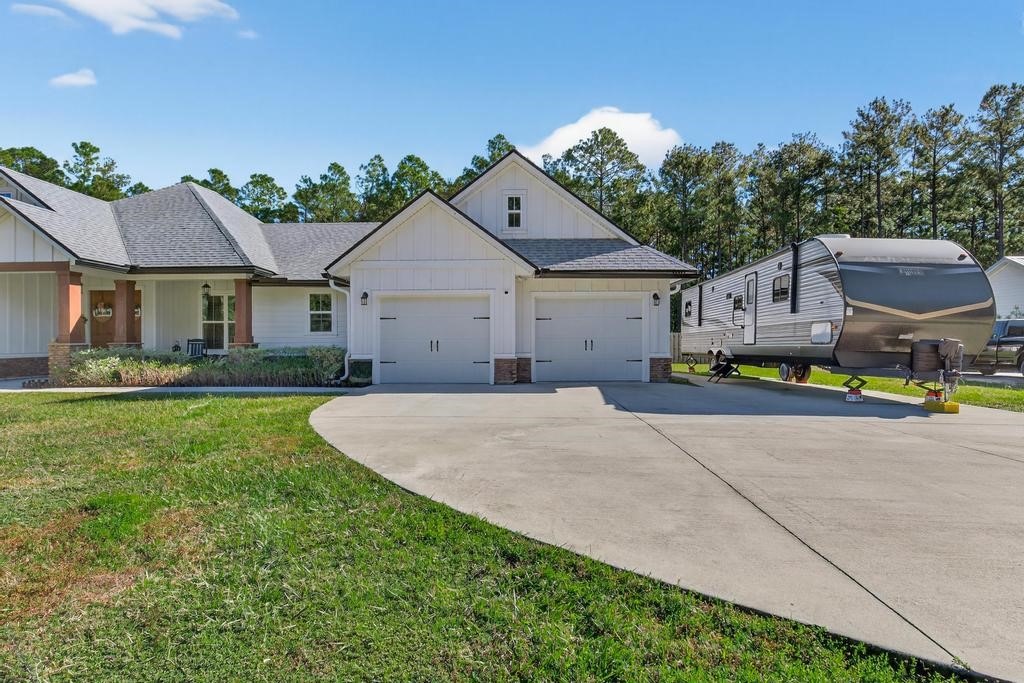 75774 Edwards Road Yulee, FL 32097 - Photo 6 of 70 a house with green field in front of it