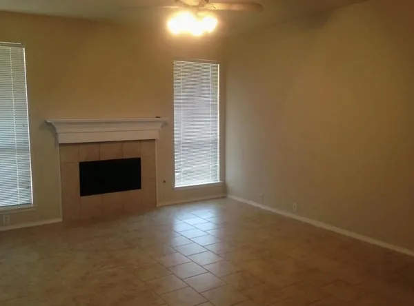 a view of empty room with a fireplace