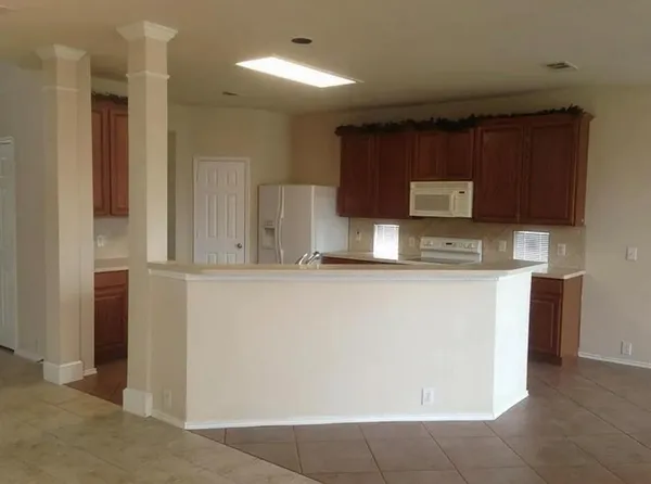 a kitchen with stainless steel appliances a refrigerator and a stove