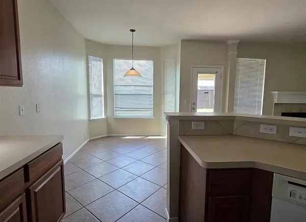 a kitchen with granite countertop a sink and a stove