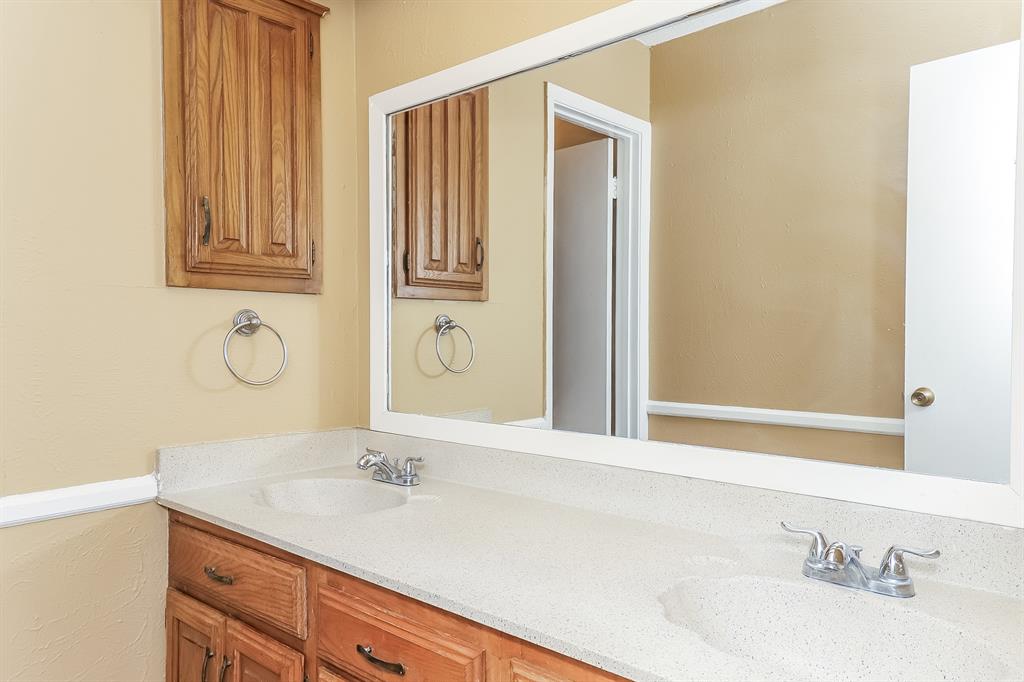 857 Via Altos Mesquite, TX 75150 - Photo 13 of 16 a bathroom with a granite countertop sink and a mirror