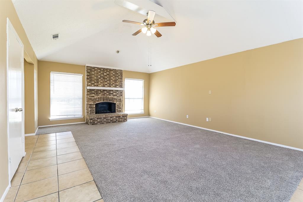 857 Via Altos Mesquite, TX 75150 - Photo 2 of 16 a view of a livingroom with a fireplace a ceiling fan and windows