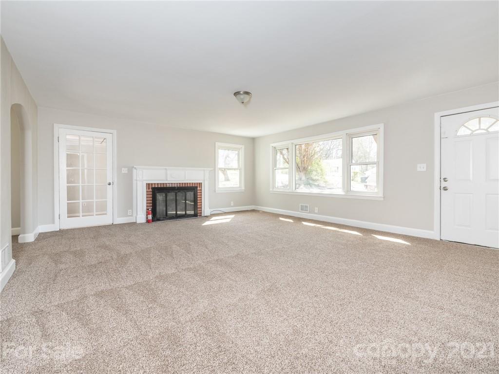 502 Davis Park Road Gastonia, NC 28052 - Photo 7 of 20 an empty room with fireplace and windows
