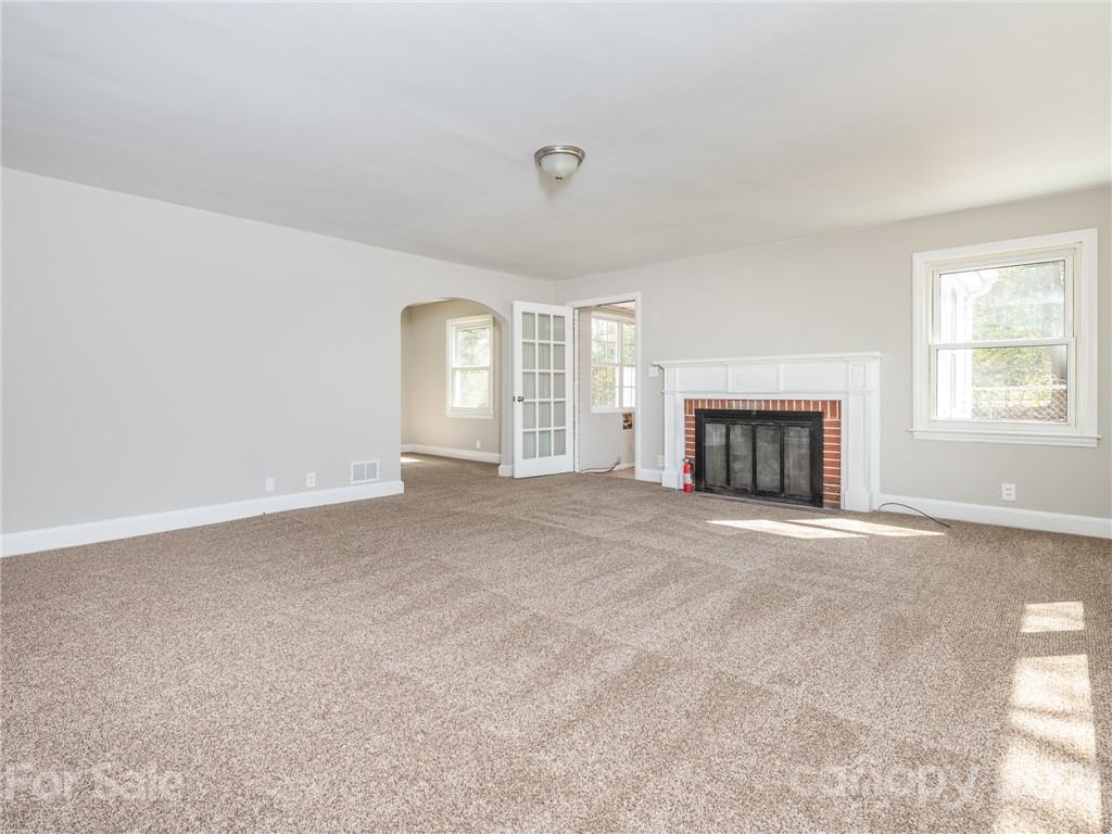 502 Davis Park Road Gastonia, NC 28052 - Photo 8 of 20 an empty room with windows and fireplace