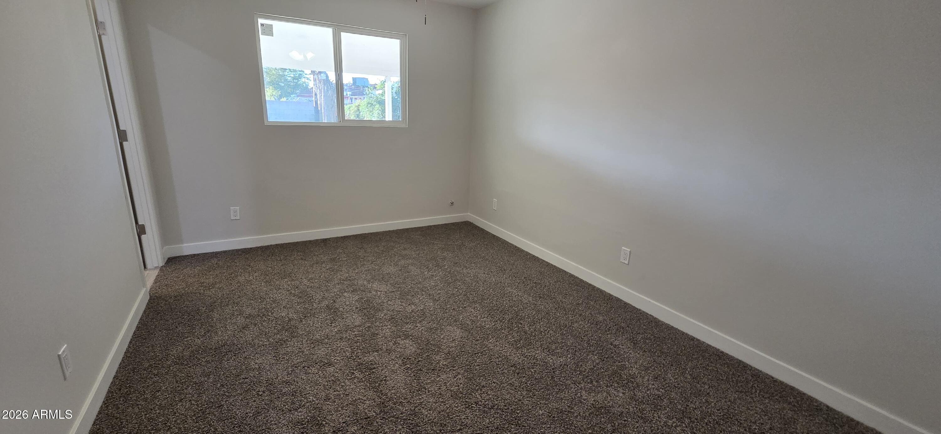 5721 West Cheery Lynn Road Phoenix, AZ 85031 - Photo 11 of 20 an empty room with windows