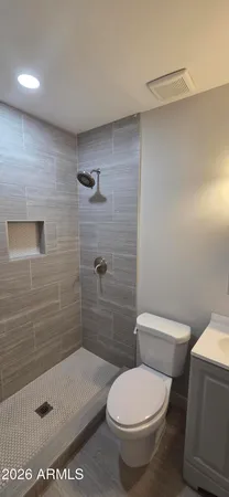 a bathroom with a toilet and a shower