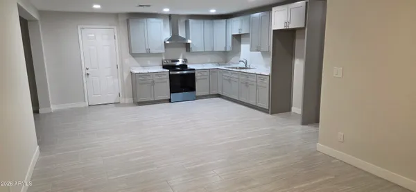 a kitchen with stainless steel appliances granite countertop a stove a refrigerator and a sink