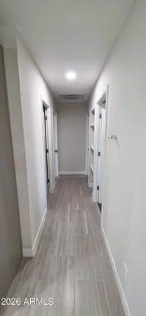 a view of a hallway with wooden floor