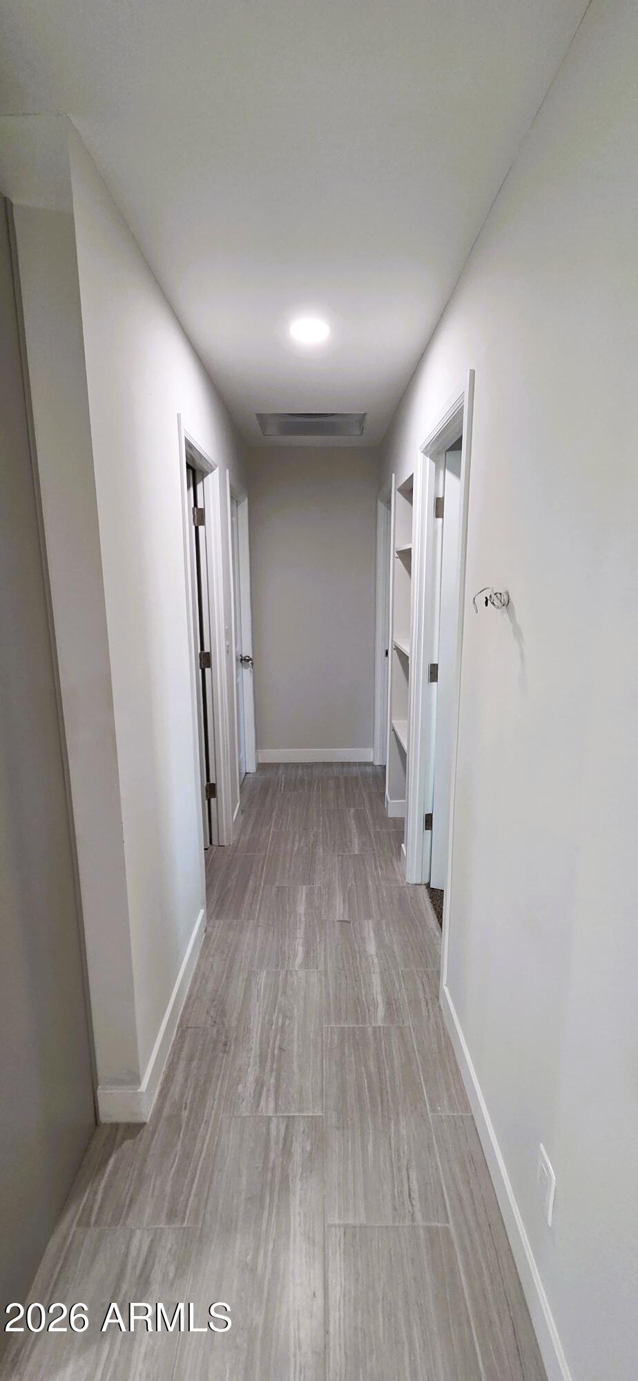 5721 West Cheery Lynn Road Phoenix, AZ 85031 - Photo 8 of 20 a view of a hallway with wooden floor
