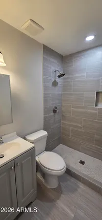 a white toilet sitting next to a bathroom sink