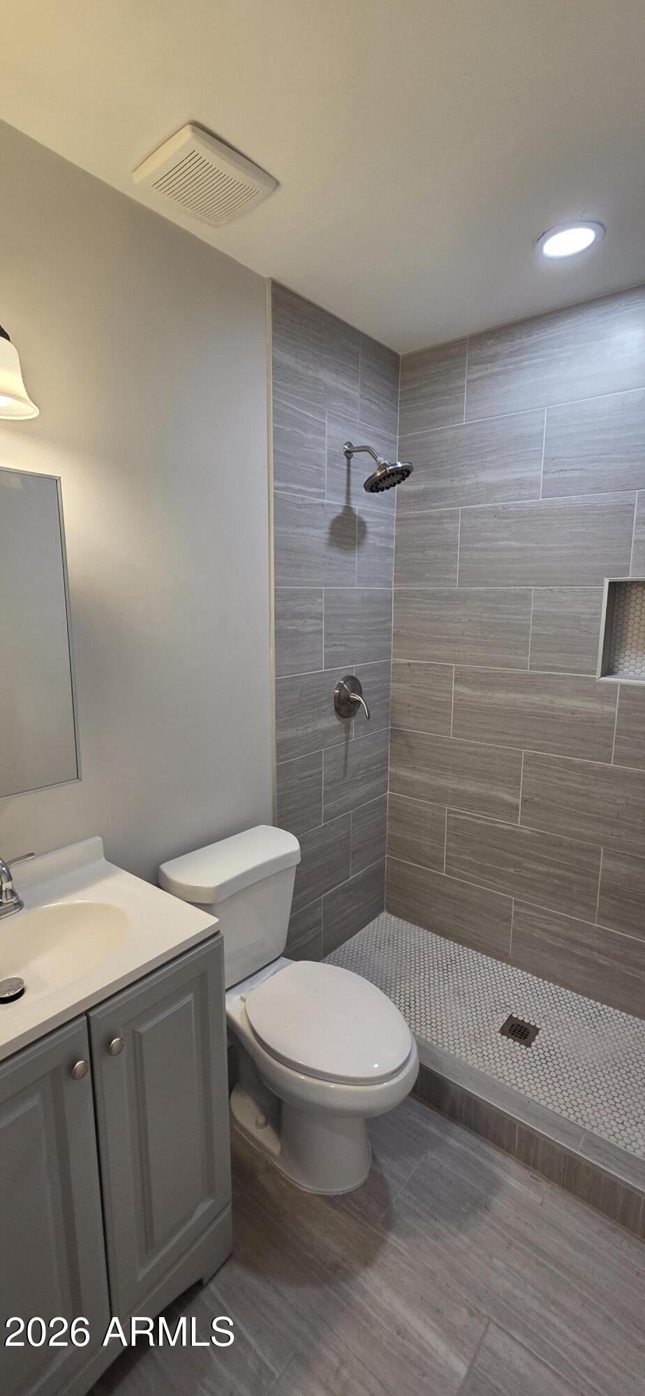 5721 West Cheery Lynn Road Phoenix, AZ 85031 - Photo 10 of 20 a white toilet sitting next to a bathroom sink