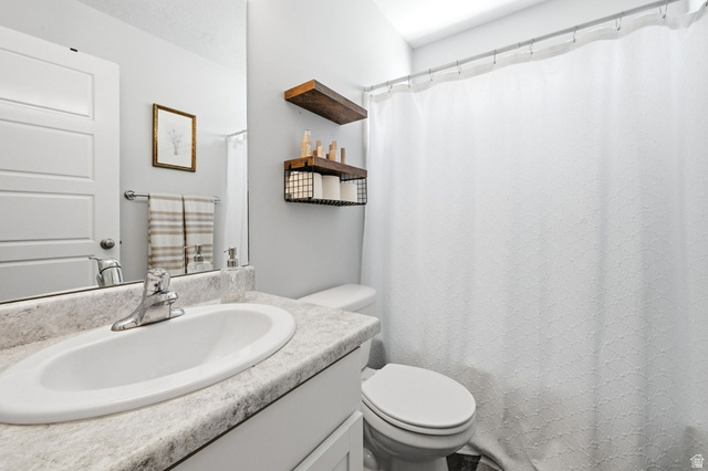 1175 Silver Hollow Road Syracuse, UT 84075 - Photo 23 of 34 Bathroom vanity with an integrated oval sink, chrome faucet, and a light-toned countertop
