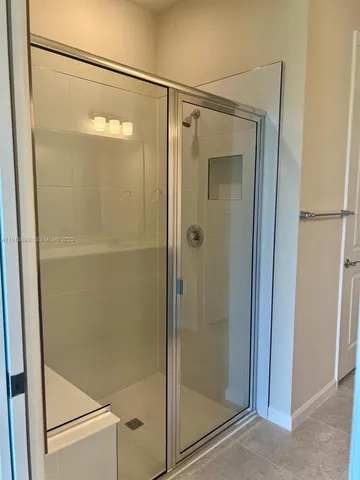 a bathroom with a glass shower door
