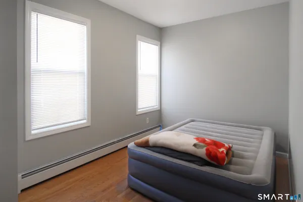 a bedroom with bed and a window