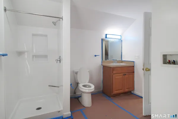 a bathroom with a toilet sink and shower