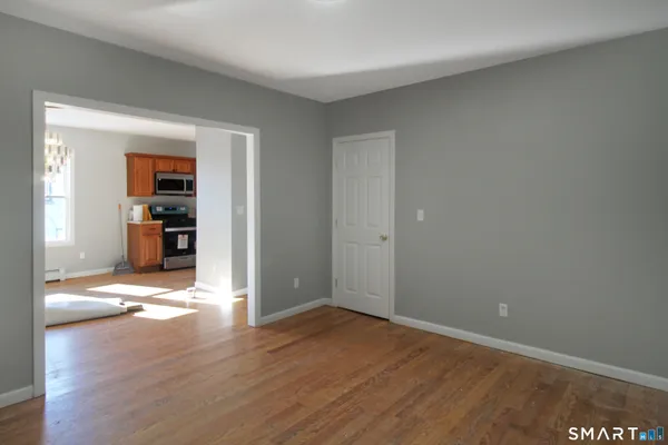 wooden floor in an empty room with a window