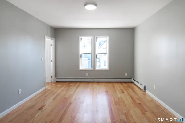 wooden floor in an empty room with a window