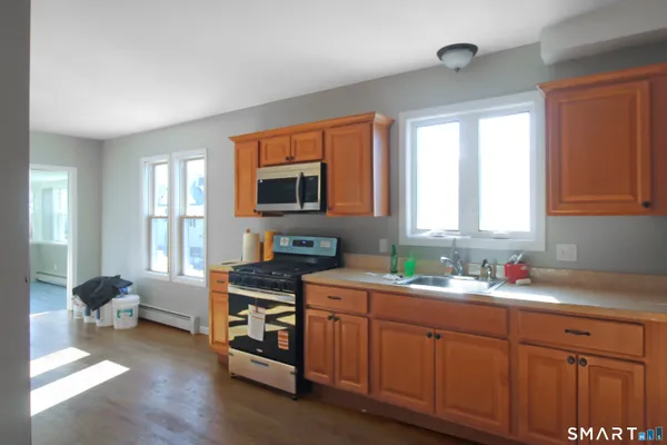 a kitchen with a sink stove and cabinets