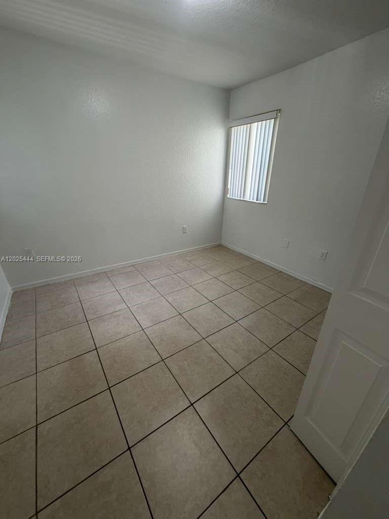 681 Southwest 7th Street, Unit 681 Florida City, FL 33034 - Photo 6 of 16 an empty room with windows
