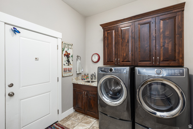 1132 Sunset Dunes Way Draper, UT 84020 - Photo 13 of 35 Laundry area with a white paneled door, dark wood cabinetry, a built-in sink with a countertop, and light-toned tile flooring