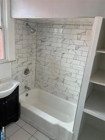 a bathroom with a bathtub and a sink