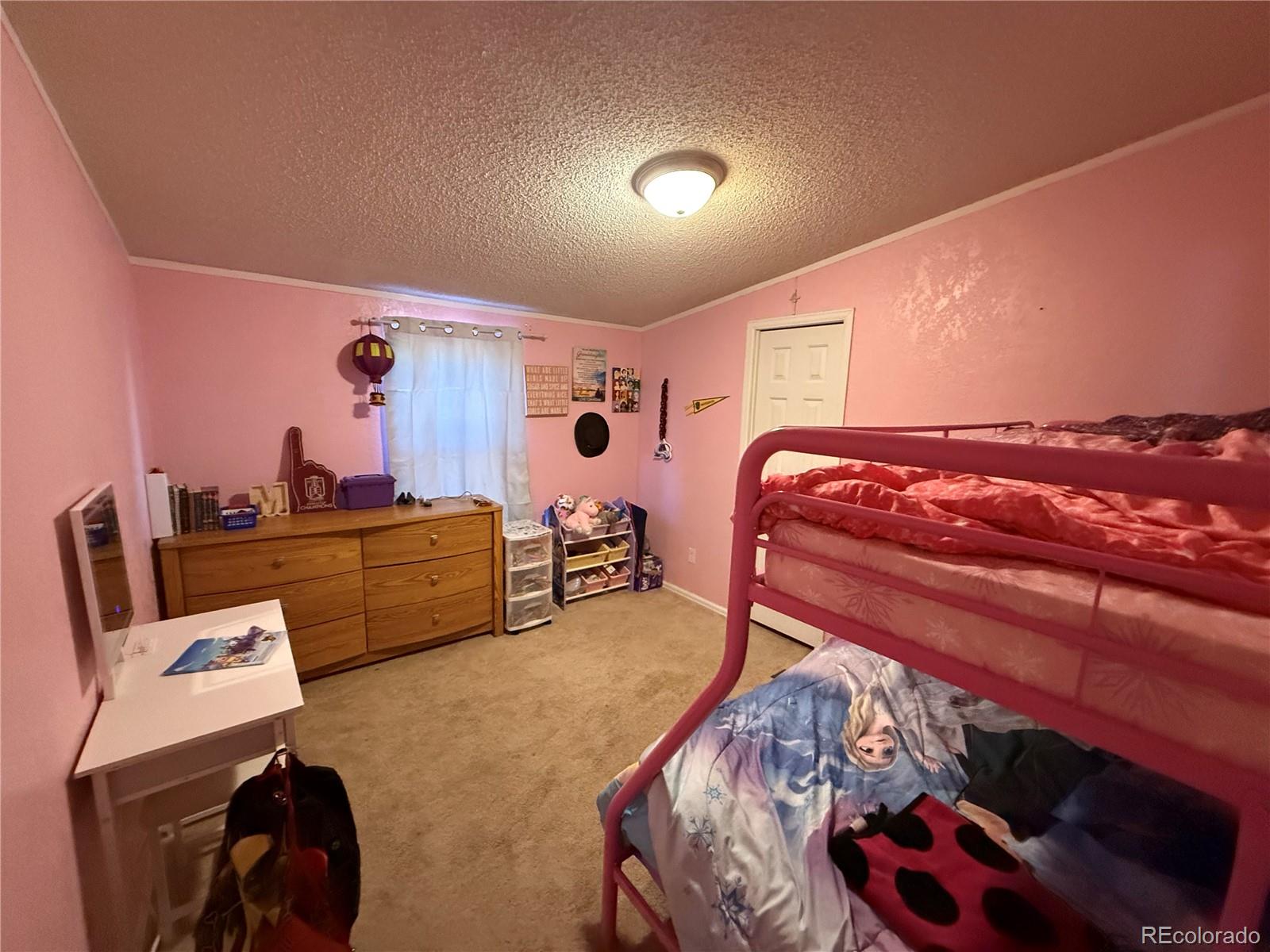 3439 West 3rd Street Road Greeley, CO 80631 - Photo 11 of 31 a bedroom with a bed and a lamp