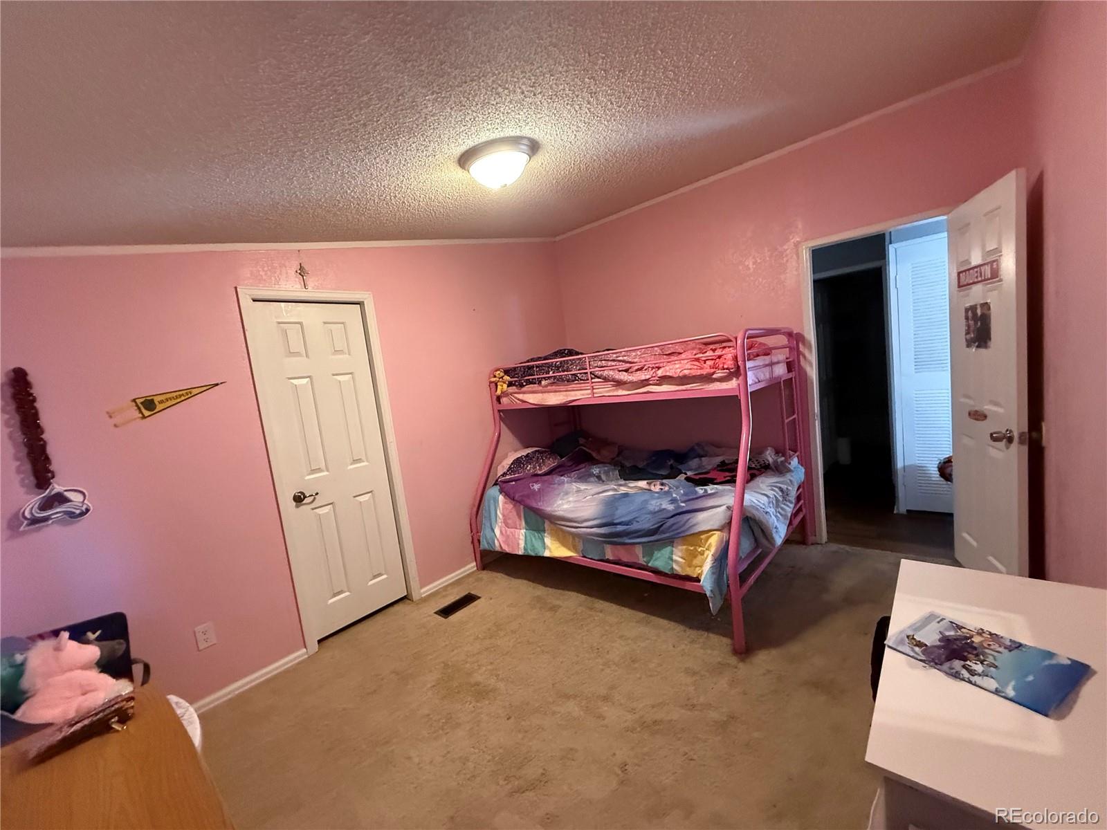 3439 West 3rd Street Road Greeley, CO 80631 - Photo 13 of 31 a bedroom with a bed and a mirror