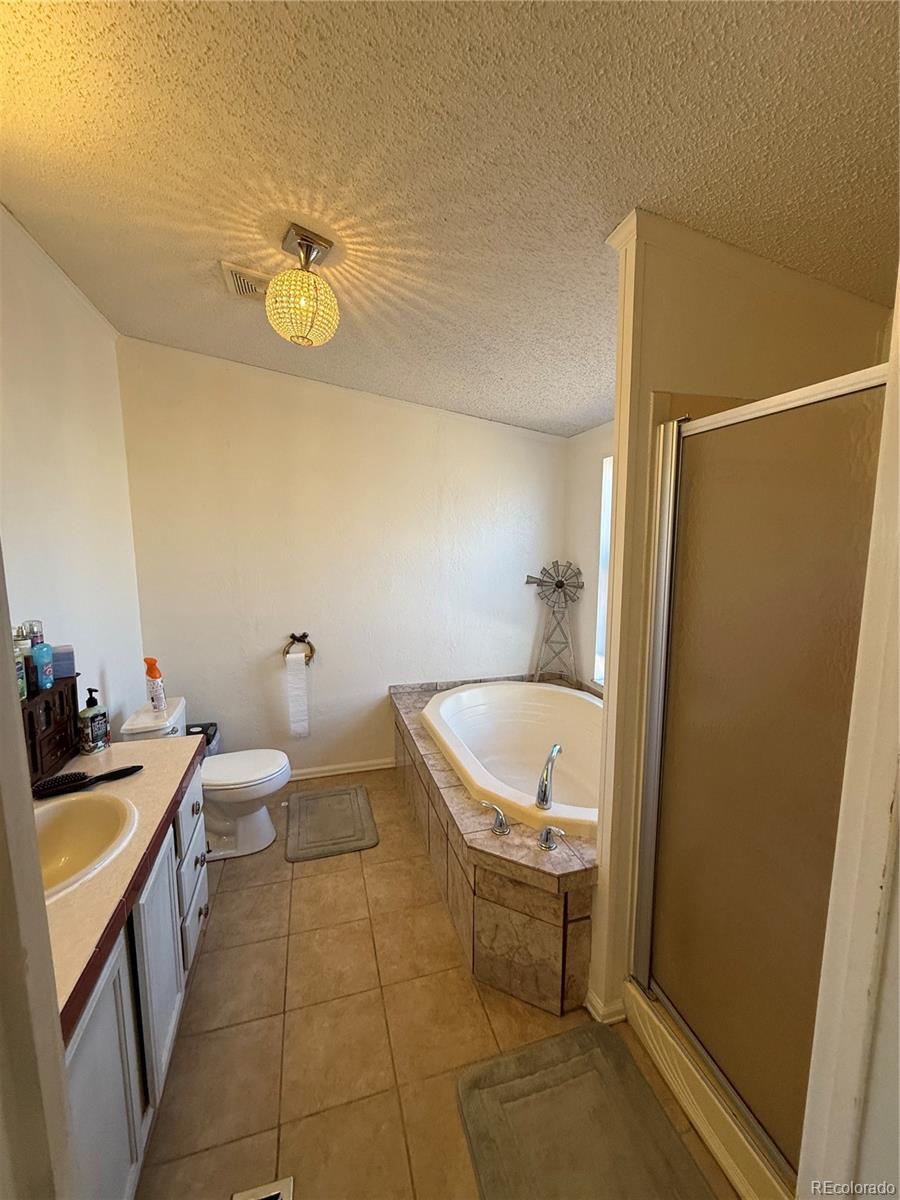 3439 West 3rd Street Road Greeley, CO 80631 - Photo 17 of 31 a bathroom with a sink a toilet and shower