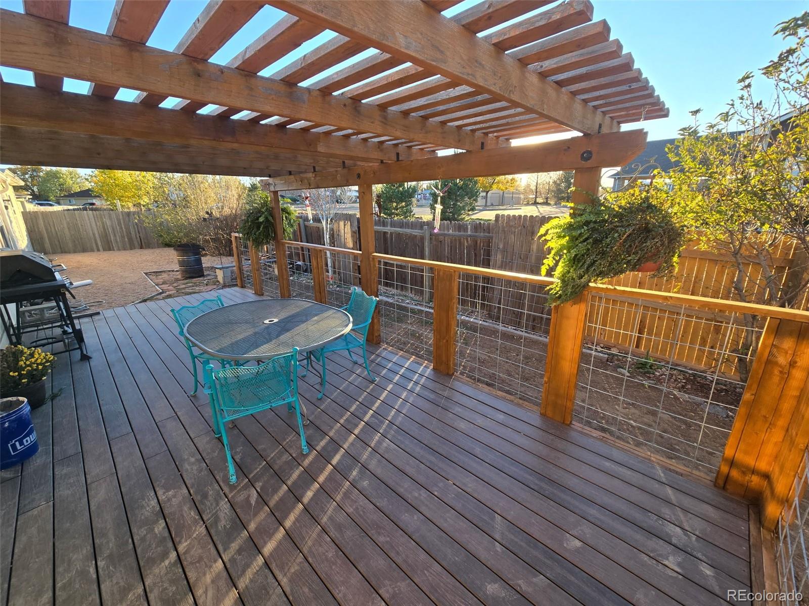 3439 West 3rd Street Road Greeley, CO 80631 - Photo 24 of 31 a view of a roof deck with dining table and chairs with wooden floor