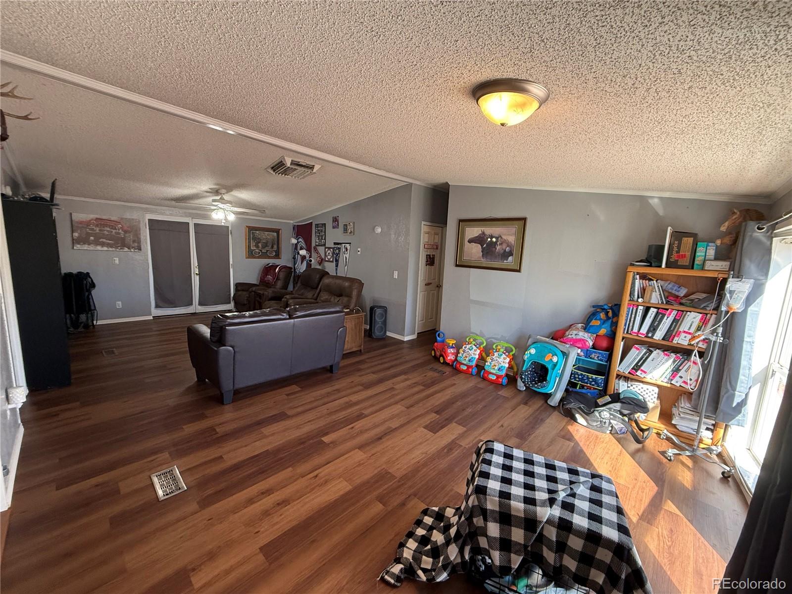 3439 West 3rd Street Road Greeley, CO 80631 - Photo 5 of 31 a bedroom with furniture and a wooden floor