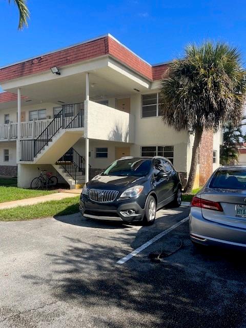 4169 Southwest 67th Avenue, Unit 209A Davie, FL 33314 - Photo 1 of 18 a front view of a house with garden