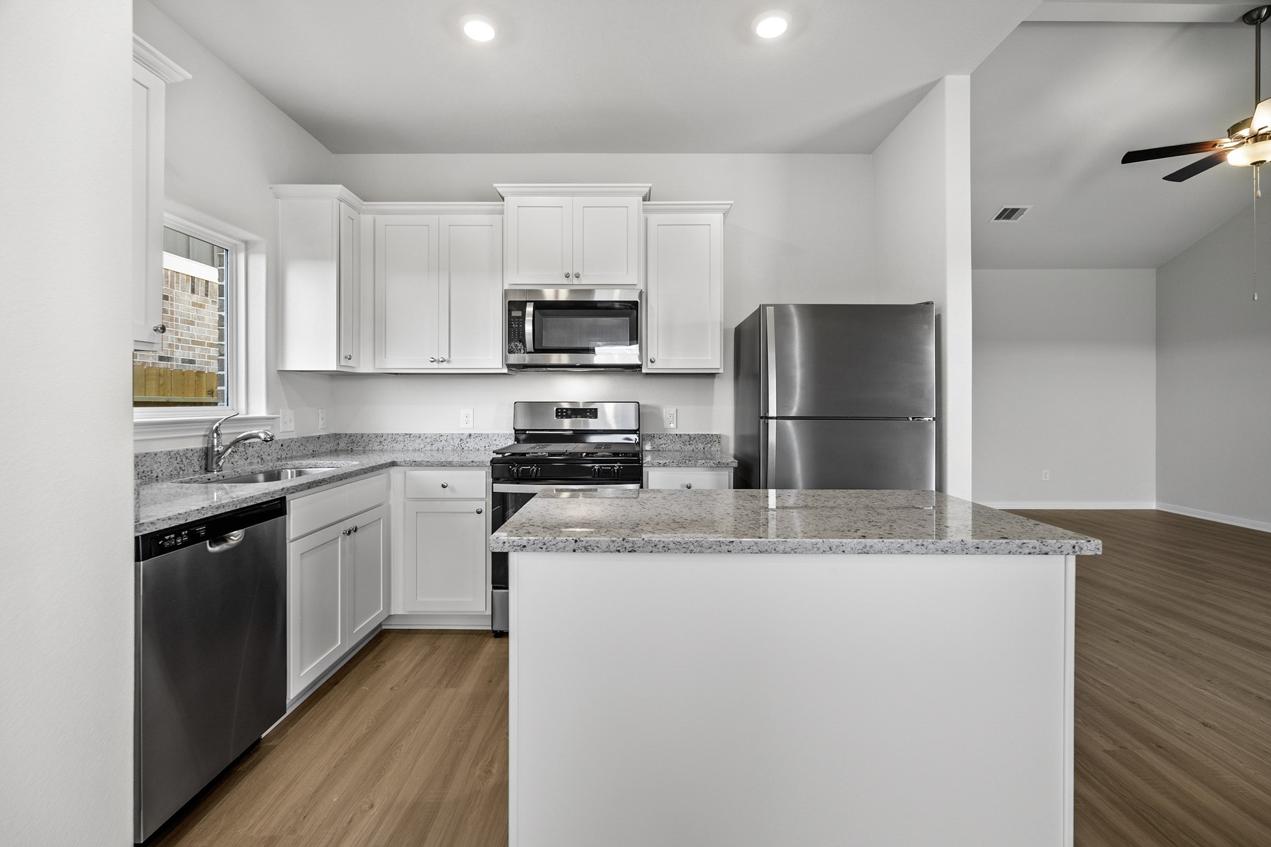 345 Fastboy Lane Waller, TX 77484 - Photo 4 of 21 a kitchen with kitchen island granite countertop a refrigerator stove top oven and sink