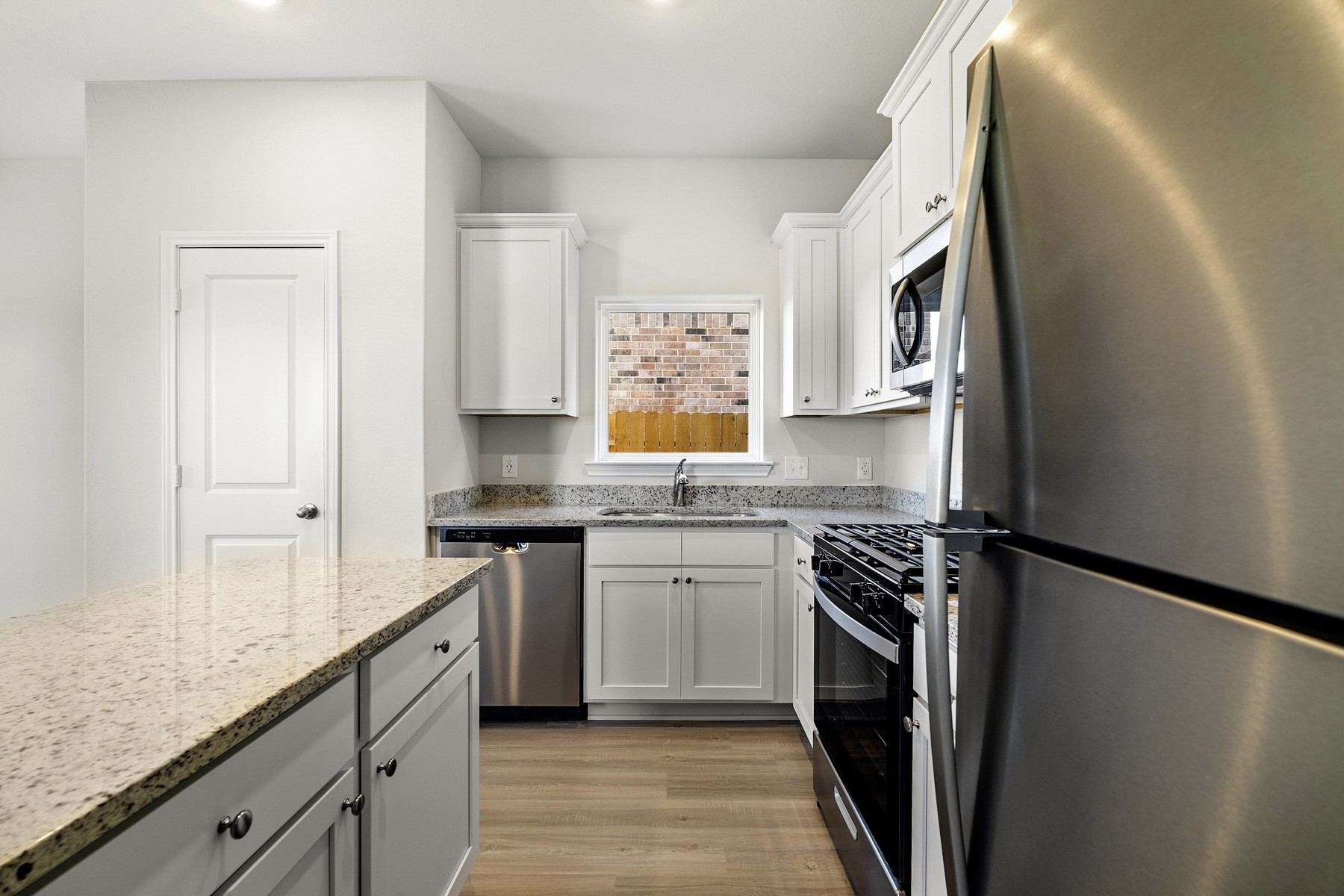 345 Fastboy Lane Waller, TX 77484 - Photo 5 of 21 a kitchen with stainless steel appliances granite countertop a stove a sink and a refrigerator
