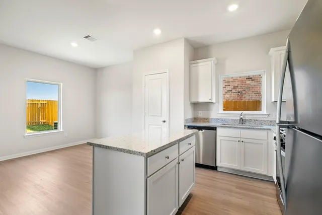 a kitchen with a refrigerator and a sink