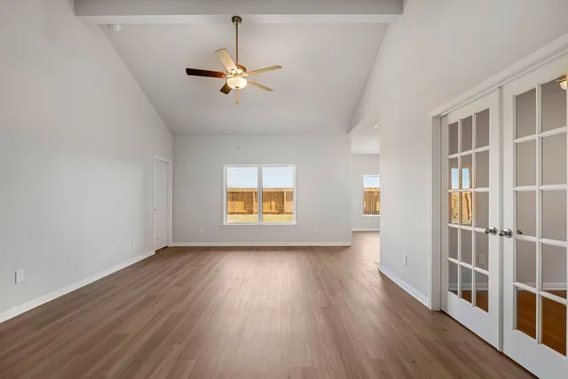 wooden floor in an empty room with a window