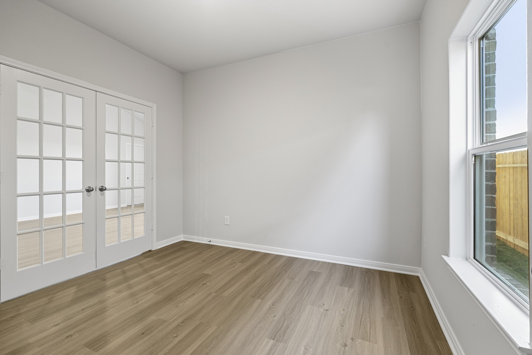 345 Fastboy Lane Waller, TX 77484 - Photo 10 of 21 an empty room with wooden floor and windows