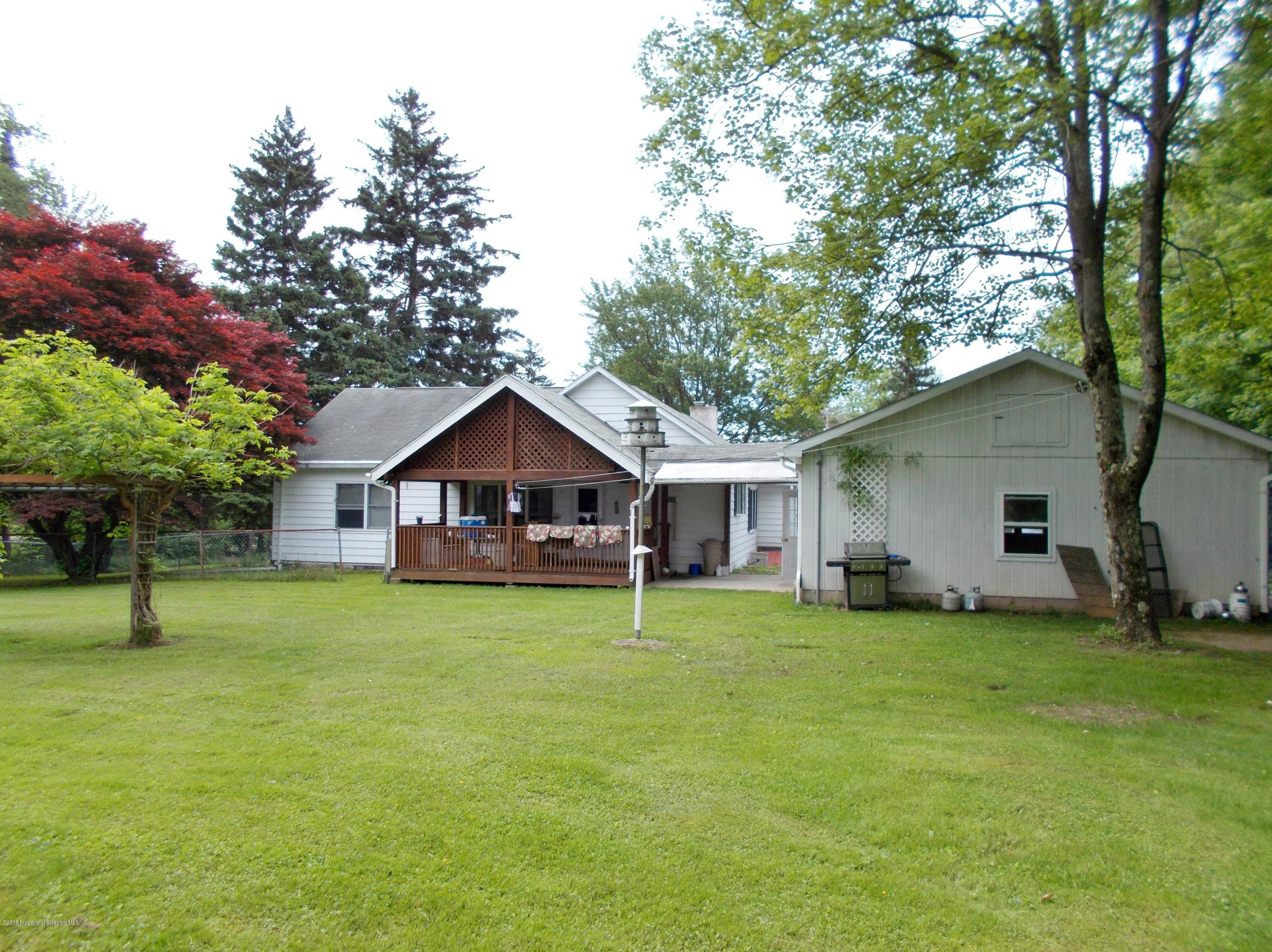 577 Pa-rt690 Road Moscow, PA 18444 - Photo 12 of 16 a house with a big yard and large trees